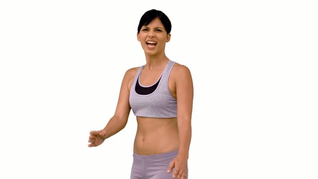 Fit woman striking a karate pose and smiling