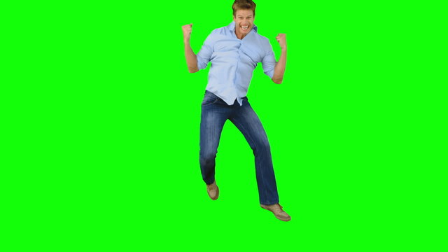 Man jumping to show his triumph on green screen