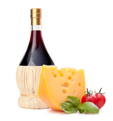 Red wine bottle, cheese and tomato still life