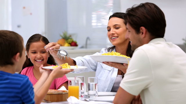 Mother serving spahetti at dinner