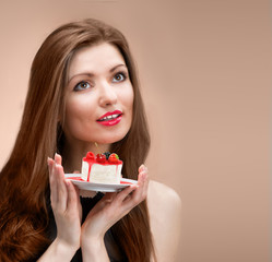 Portrait of a pretty woman with the cake looking up