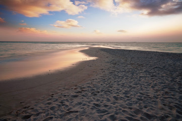 Sunset on the beach with view to the ocean and sky