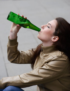 Woman Drinking Beer From The Bottle