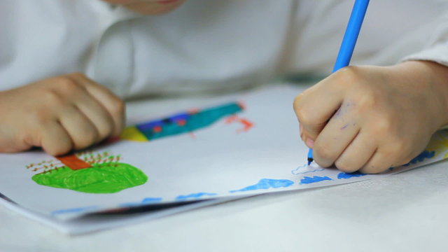 left-handed child , boy draws
