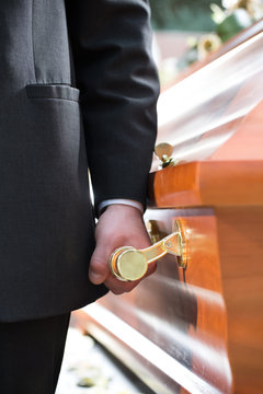 Coffin Bearer Carrying Casket At Funeral