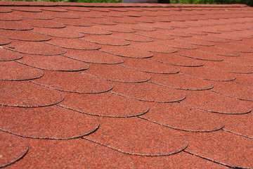 Red asphalt shingle roofing on a roof
