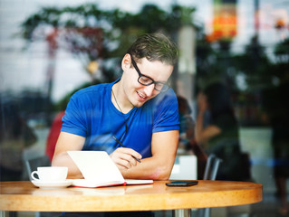 handsome man thinking in cafe, office or home