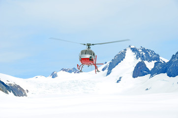 Fototapeta na wymiar Helicopter taking off from the snow