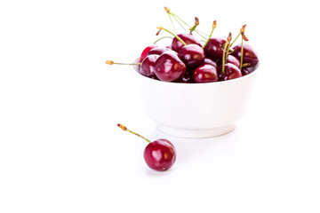 Sweet fresh cherry in a bowl isolated