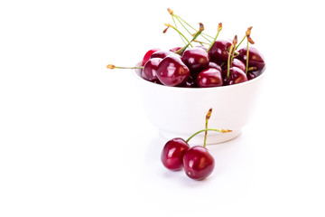 Sweet fresh cherry in a bowl isolated