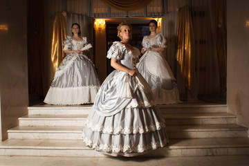 Three young women in ball gowns