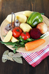 Composition of vegetables on wooden background