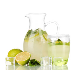 Lemonade in pitcher and glass isolated on white