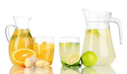 Orange and lemon lemonade in pitchers and glasses isolated
