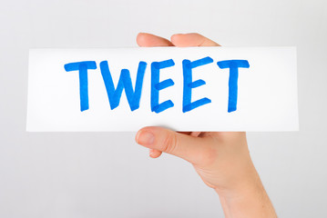 Hand showing tweet word