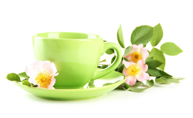 Cup of herbal tea with hip rose flowers, isolated on white
