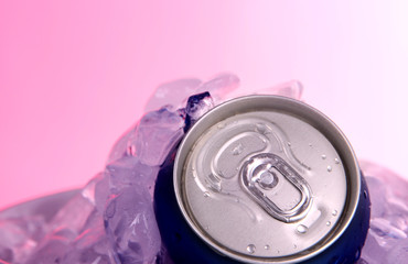 Metal tin with ice on pink background