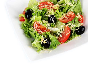 Light salad on plate isolated on white