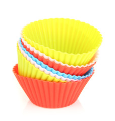 Stack of colorful cupcake cases isolated on white