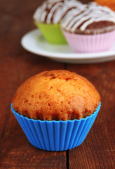 Sweet cupcakes on wooden table