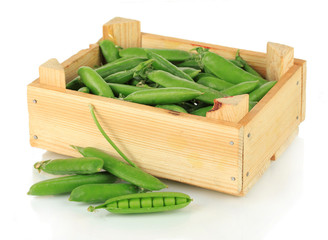 Sweet green peas in wooden box isolated on white