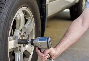 Using air wrench to remove car tire