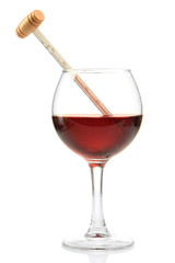 Glass of wine with thermometer, isolated on white