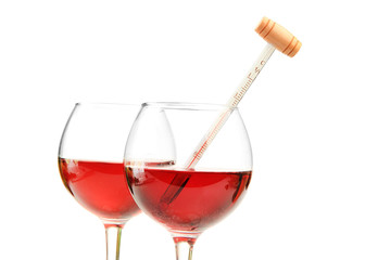 Glasses of wine with thermometer, isolated on white