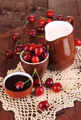 Ripe red cherry berries in cup and chocolate sauce
