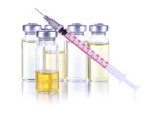 Obraz na płótnie Canvas Medical bottles and syringe on light gray tone