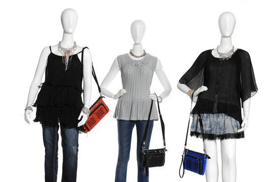 Three  female clothing in jeans with scarf, bag on mannequin