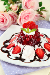 Tasty jelly dessert with fresh berries, on pink roses