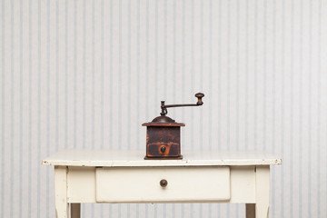 Coffee grinder on the vintage table.