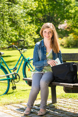 Fototapeta na wymiar Teenager student girl sitting on bench