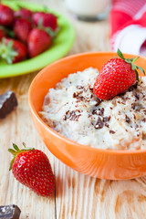 cereal with milk and ripe strawberries