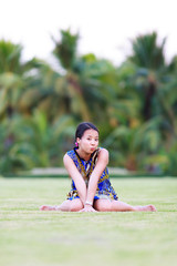 Asian woman sit on ground in park