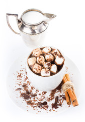 Hot dark chocolate with mini marshmallow, cinnamon and milk in a