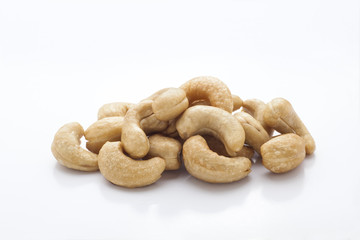 pile of roasted cashew nuts in isolated white background