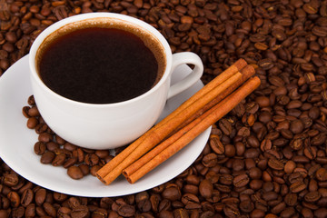 Cup of coffee with cinnamon sticks