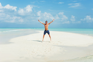 Fototapeta na wymiar Man jumps on the beautiful beach