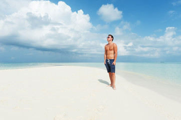 Man looks into the distance on the beautiful beach