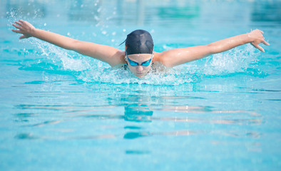 Young girl swimming butterfly stroke style
