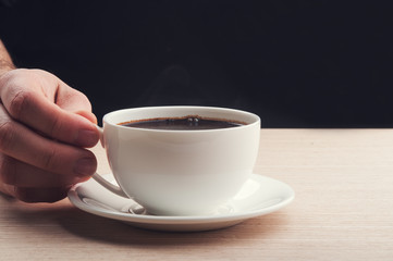 man holding cup of coffee