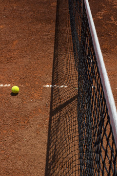 tennis ball on red clay
