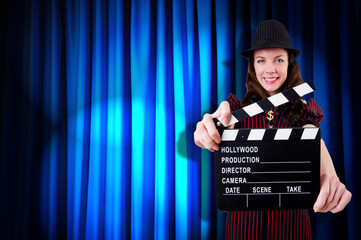 Woman gangster with movie clapper
