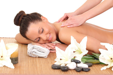 young woman relaxing beeing massaged in spa saloon