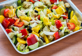 Raw marinated vegetables on a baking tray