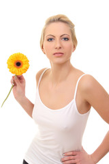 beautiful young blond woman with a flower in her hands