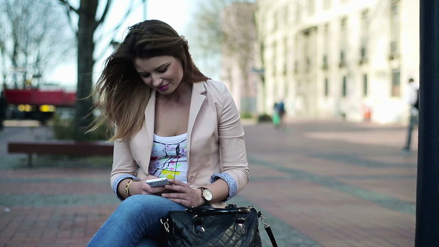 Young woman using smartphone in the city