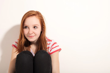 portrait of cute redheaded girl, wall background